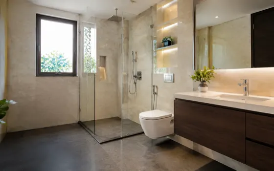 A clean modern bathroom with wall tiles and polished chrome fittings
