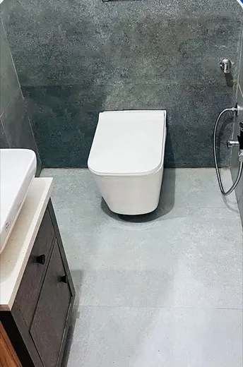 Bathroom with a stained floor and toilet before cleaning, and the same bathroom with clean floor tiles and a descaled WC